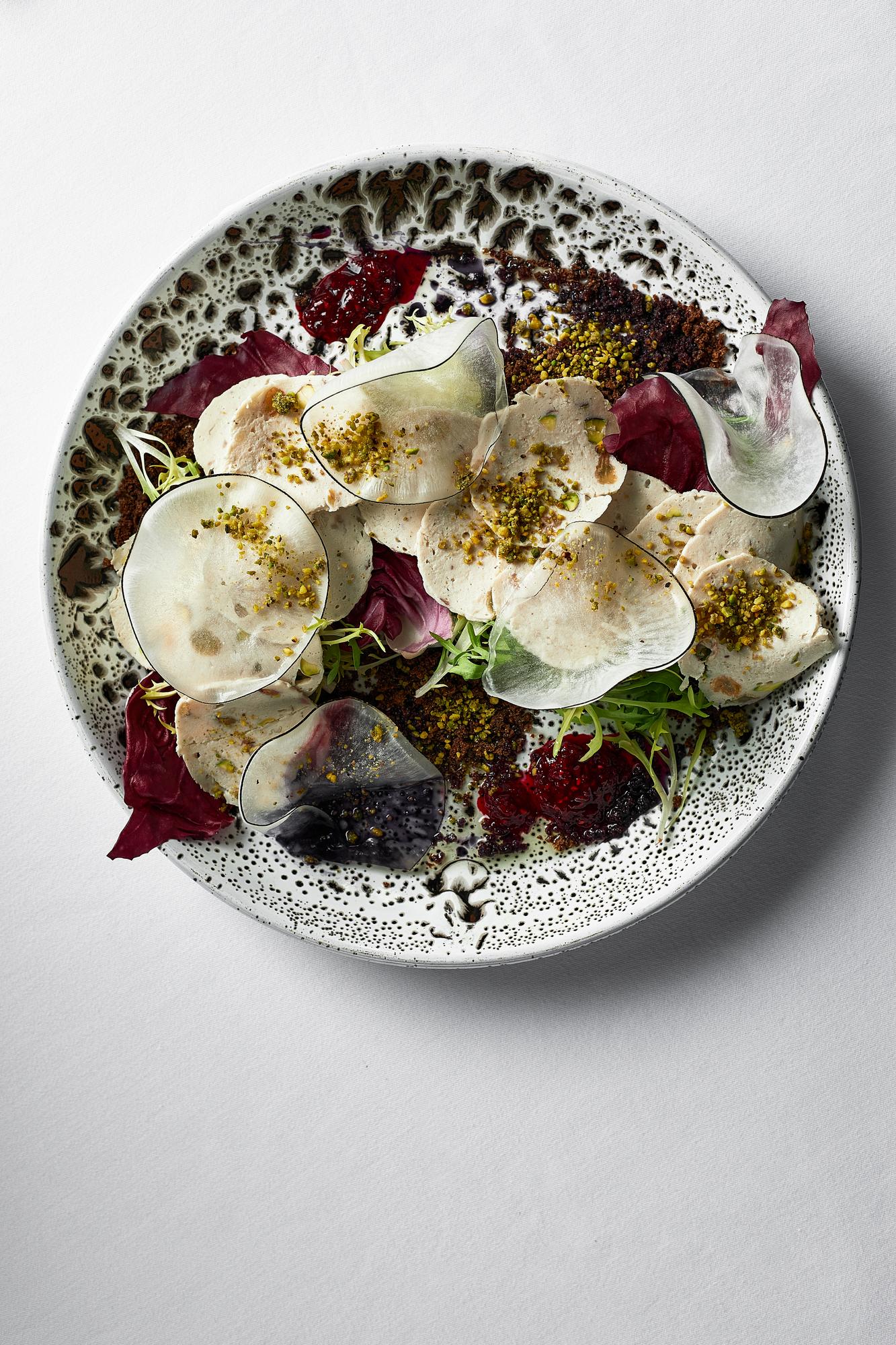 close-up plated dish with edible flowers